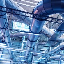 Air conditioning of buildings. Background of ventilation pipes. Laying of engineering networks. Industrial background